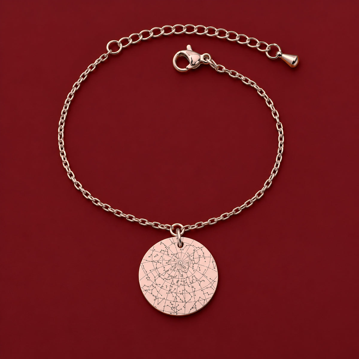 Bracelet Personnalisé avec carte des étoiles, finition or rose, sur fond rouge sanguine.