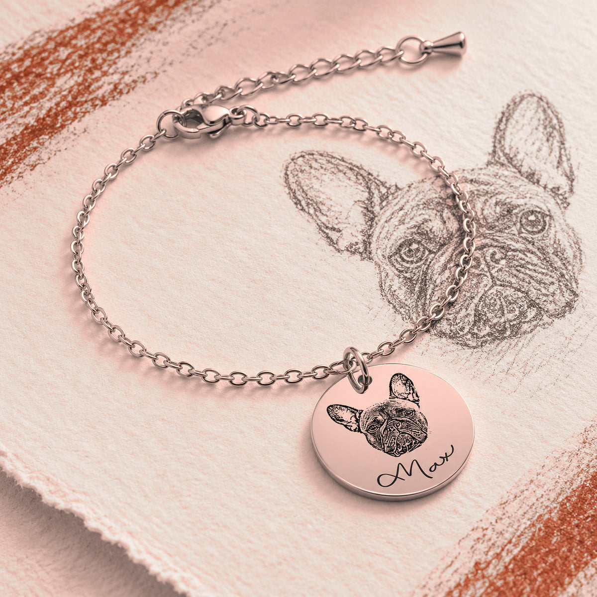 Bracelet Personnalisé Gravé Portrait de Chien, finition or rose, près d’un croquis au crayon.