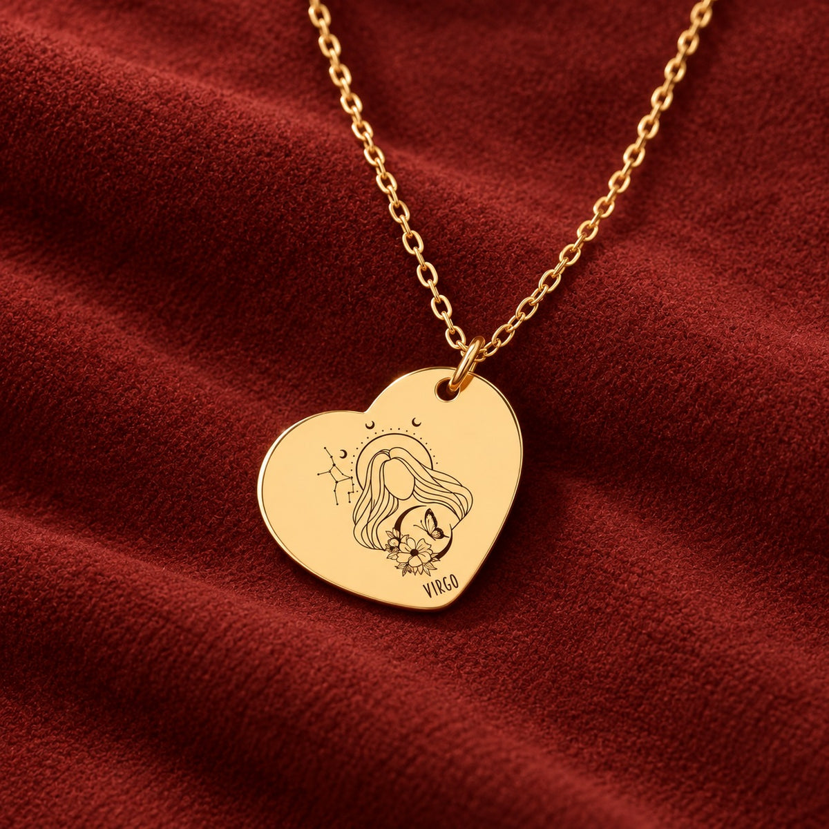 Médaille en cœur dorée avec motif du signe Vierge et ornements, sur suédine rouge sanguine.