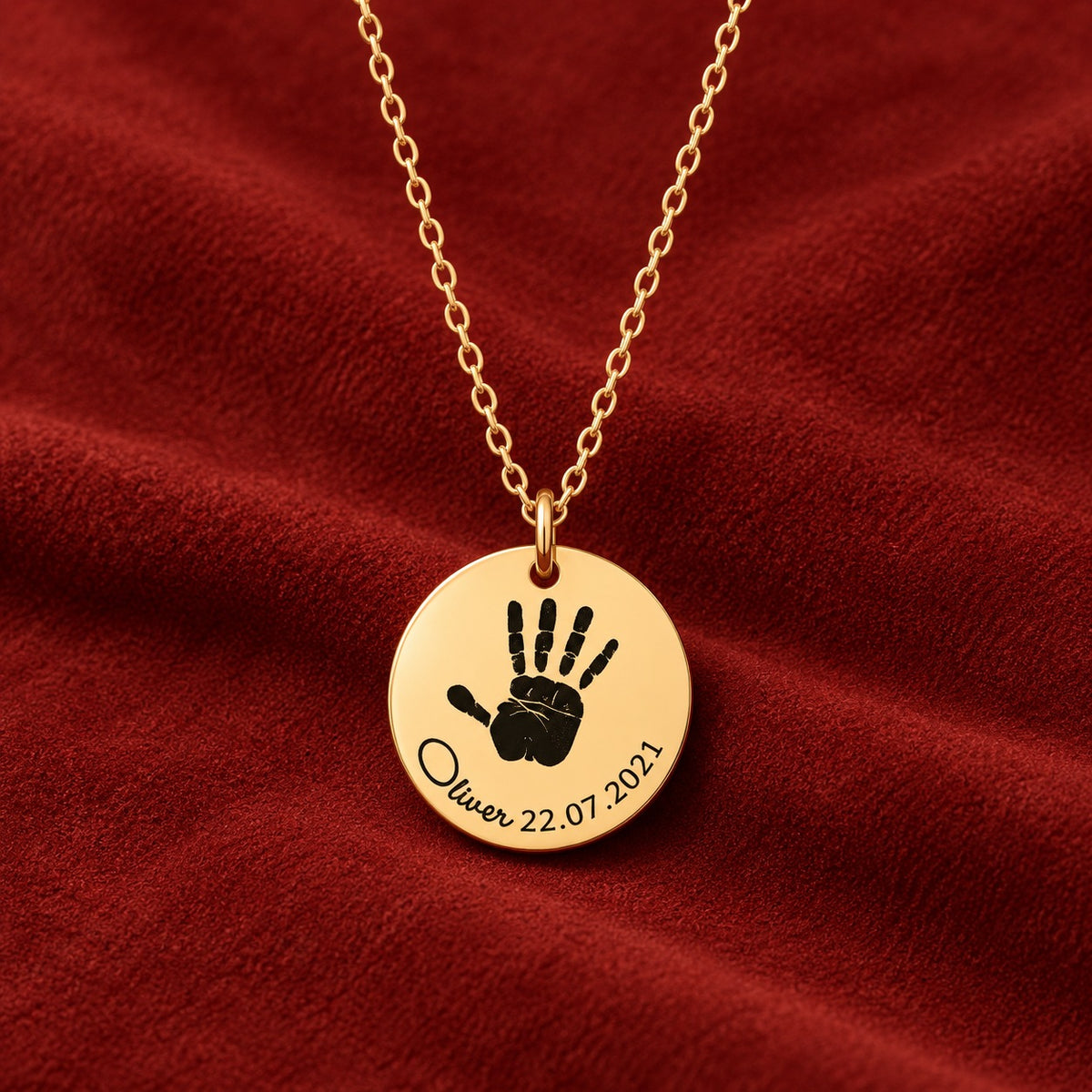 Collier Empreinte de Main doré sur suédine rouge sanguine, détail de la gravure.