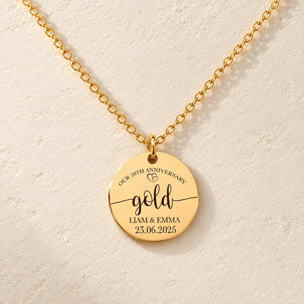 Collier Médaille Anniversaire de Mariage 50 ans doré, médaille ronde gravée avec inscription « gold », prénoms Liam et Emma et date 23.06.2025, sur fond ivoire.