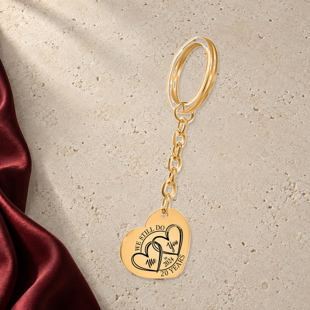 Porte-clés Coeur Anniversaire de Mariage 20 ans (noces de porcelaine) en finition dorée sur pierre claire, avec étoffe rouge sanguine ; exemple de personnalisation.
