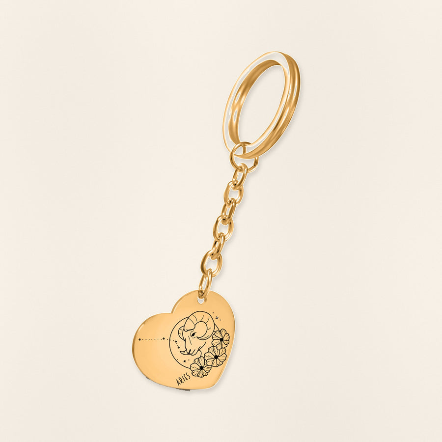 Porte-clés Coeur Signe Astrologique Bélier en finition dorée, exemple de gravure sur fond ivoire texturé.