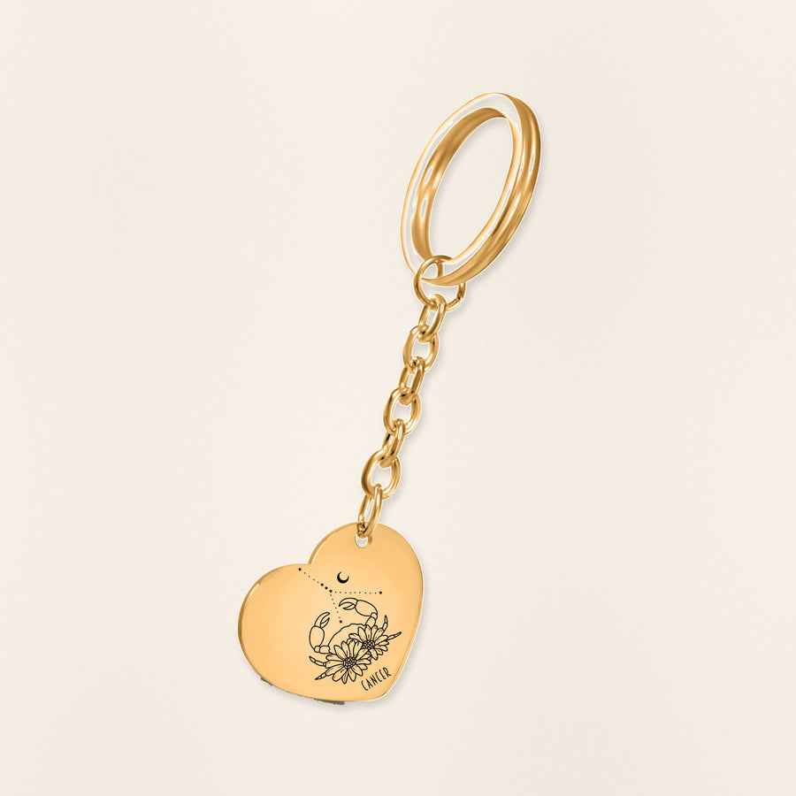 Porte-clés Coeur Signe Astrologique Cancer en finition dorée, exemple de gravure sur fond ivoire texturé.