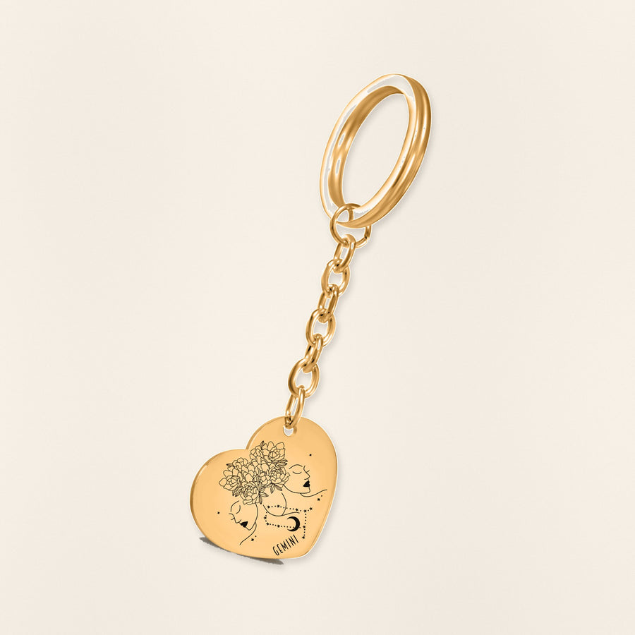 Porte-clés Coeur Signe Astrologique Gémeaux en finition dorée, exemple de gravure sur fond ivoire texturé.